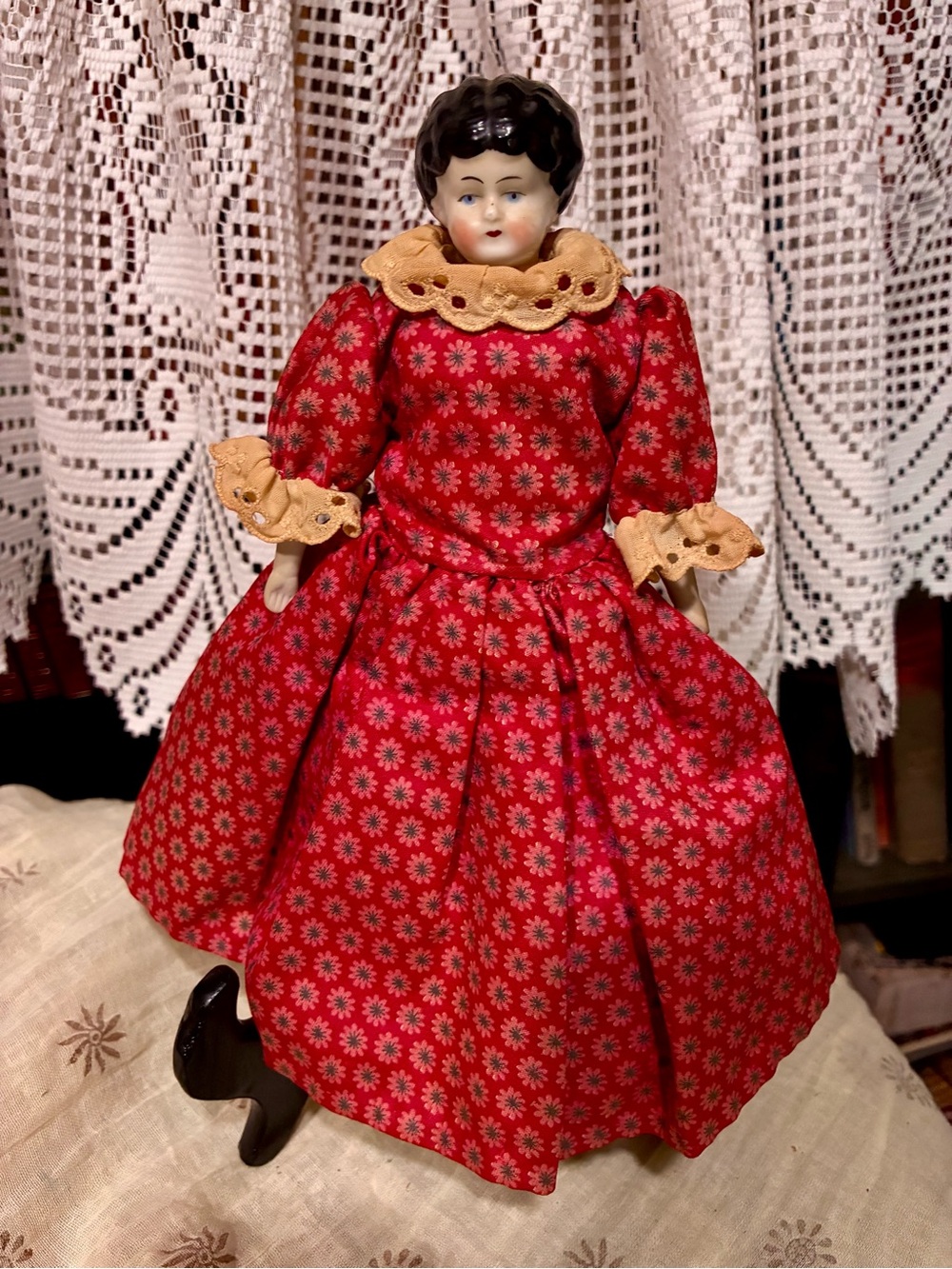 Vintage doll with China head hand and feet, painted features in red dress